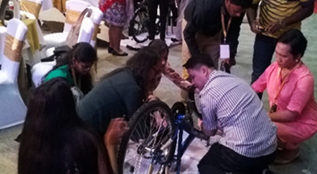 TINKR participants working together to build an accessible mobility device