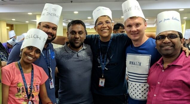 A TINKR team wearing chef hats during a creative food truck simulation